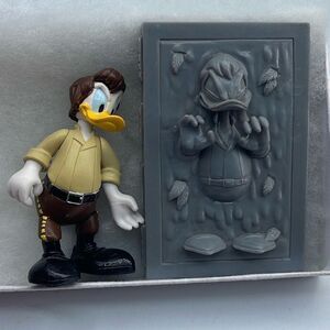 Set of two 2010 Disney Florida Han Solo / carbonite action figures .